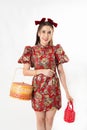Chinese New Year concept, Woman holding a basket of food and red basket ,meaning to be happy healthy and wealthy year, Chinese New