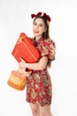 Chinese New Year concept, Woman holding a basket of food and red basket ,meaning to be happy healthy and wealthy year, Chinese New