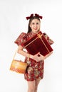 Chinese New Year concept, Woman holding a basket of food and red present box ,meaning to be happy healthy and wealthy year,