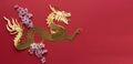 Chinese New Year. Dragon cut out in gilt paper with plum blossom decoration on red background. Copy space Royalty Free Stock Photo