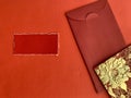 Red and golden color Chinese New Year envelopes with torn red paper background. Chinese New Year concept.