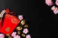 Chinese new year festival decorations pow or red packet, orange and gold ingots or golden lump on a black background. Chinese Royalty Free Stock Photo