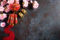 Chinese new year festival decorations pow or red packet, orange and gold ingots or golden lump on a black stone texture background Royalty Free Stock Photo