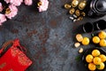 Chinese new year festival decorations pow or red packet, orange and gold ingots or golden lump on a black stone texture background Royalty Free Stock Photo