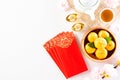 Chinese new year festival decorations pow or red packet, orange and gold ingots or golden lump on a white background. Chinese Royalty Free Stock Photo