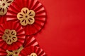 Chinese New Year festival or wedding decorations on red background. Red paper fans with gold decorations top view. Lunar New Year