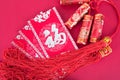 Chinese New Year festive firecracker pendants and red envelopes.The Chinese characters in the picture mean`happiness`