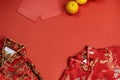 Chinese new year fresh oranges and angpao pocket and qipao on red paper background Royalty Free Stock Photo