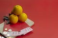 Chinese new year fresh oranges and angpao pocket with wooden board on red paper background Royalty Free Stock Photo