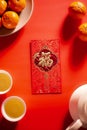 Chinese New Year and Lunar New Year celebrations red envelope orange and hot tea.