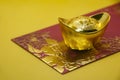 Chinese New Year packets with Chinese Gold Ingots on yellow background. Chinese New Year Celebration.