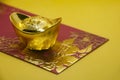 Chinese New Year packets with Chinese Gold Ingots on yellow background. Chinese New Year Celebration.