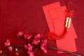 Chinese New Year, red envelope with plum blossom flower and lucky decorative golden coins with Chinese blessing words means