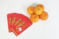 Chinese New Year Red Packet and mandarin oranges Royalty Free Stock Photo