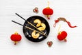 Chinese New Year tabble setting with fortune cookies and golden chopsticks Royalty Free Stock Photo