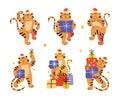 Chinese new year of the tiger 2022. Collection of cute and funny tigers in Santa Claus hats with colorful gift boxes Royalty Free Stock Photo