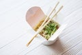 Chinese noodles in takeaway box on wooden background. Food. Royalty Free Stock Photo