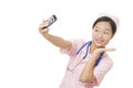 Asian nurse using a cell photo to take a Selfie isolated on white background Royalty Free Stock Photo