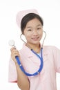 Portrait of a beautiful Asian nurse holding a stethoscope isolated on white background Royalty Free Stock Photo