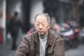 A chinese old man riding a bike in Hangzhou