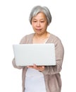 Chinese old woman use of notebook computer Royalty Free Stock Photo