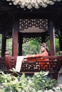 Chinese opera woman.Practicing Peking Opera in the Pavilion garden, Hand in a fan , Colorful, china Royalty Free Stock Photo