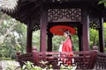 Chinese opera woman.Practicing Peking Opera in the Pavilion garden With a red umbrella, Colorful, china Royalty Free Stock Photo