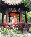 Chinese opera woman.Practicing Peking Opera in the Pavilion garden With a red umbrella, Colorful, china Royalty Free Stock Photo
