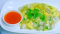 Chinese oyster omelette with chili sauce in white plate Royalty Free Stock Photo