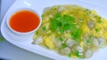 Chinese oyster omelette with chili sauce in white plate Royalty Free Stock Photo