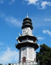 Chinese pagoda clock tower soars in blue sky Royalty Free Stock Photo