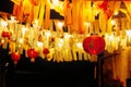 Chinese paper red lanterns hang with garlands of ribbons and lamps at night in the yard Royalty Free Stock Photo