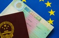 Chinese Passport on european flag schengen visa Royalty Free Stock Photo