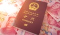 Chinese passport with some 100 Chinese Yuan notes. Royalty Free Stock Photo