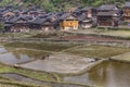 Chinese peasants working in a flooded field near village. Royalty Free Stock Photo