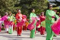 Chinese people in colorful traditional silk clothes dancing