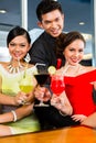 Chinese people drinking cocktails in luxury cocktail bar Royalty Free Stock Photo