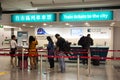 Chinese people and foreigner traveler waiting line up buy Buses ticket from tickets counter at Hong Kong Airport