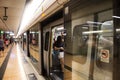 Chinese people and foreigner travelers waiting in underground at Mong Kok railway statio in Hong Kong, China