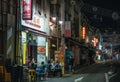 Chinese people have dinner in street cafe at night in Chinatown