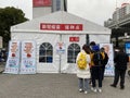 Chinese people outside temporary vaccination centre