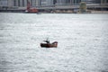 Chinese people paddle and floating wooden boat in the sea at Hong Kong, Mainland China