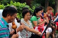 Chinese people playing on traditional flutes in Jingshan park