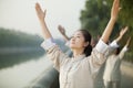 Chinese People Practicing Tai Ji, Arms Raised, Outdoors