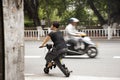 Chinese people ride and bike new innovation scooter bicycle electric on the road in old town area at Shantou or Swatow, China