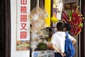 Chinese people and travelers selecting and buy chinese dessert fruit coating sugar in small local shop in old town at Chaozhou