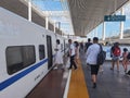 Travelers with masks boarding train, China