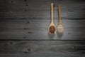 Chinese pepper and white peper on wooden spoons and wooden background Royalty Free Stock Photo