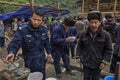 Chinese policeman on a rural celebration eating using wooden chopsticks.