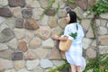 Chinese Portrait of young beautiful woman against to wall in park Royalty Free Stock Photo
